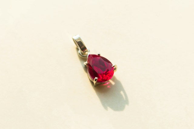 Silver pendant with red gemstone